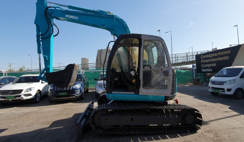 
								Kobelco 60 SR lleno									